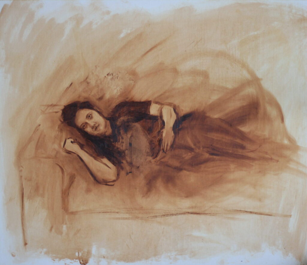 This oil painting on beechwood panel is 70cm wide and 60cm high, a full body portrait in a range of earthy tones of burnt umber, from solid dark chocolatey brown to pale ochre. Lying horizontally across the centre of the image is the titular figure, Maggie, a late twenties Anglo-Australian woman, laying on her right side on a couch. Her face is on the left of the canvas, resting upon a cushion near the arm of the couch, and her right arm is curled up nearby. Her face is highly detailed, almost photorealistic, but softened by the gestural style of the artist. Maggie’s eyes are open, gazing directly at the viewer, or perhaps just past us. Her face is oval, unwrinkled, and natural with gentle shading below her eyes, small, precise brushstrokes forming her dark eyebrows. Her mouth is ever so slightly open, with a neutral expression. Her long hair is in a loose style piled on her head, her left ear peeking through the loose hair trailing down the side of her face. Her left arm lies vertically down across the dark, nearly black t-shirt she wears, and her body remains only a rough shape, blending across the right hand side of the image, merging with the loosely figured couch and the large, motion filled brushstrokes which form the background.