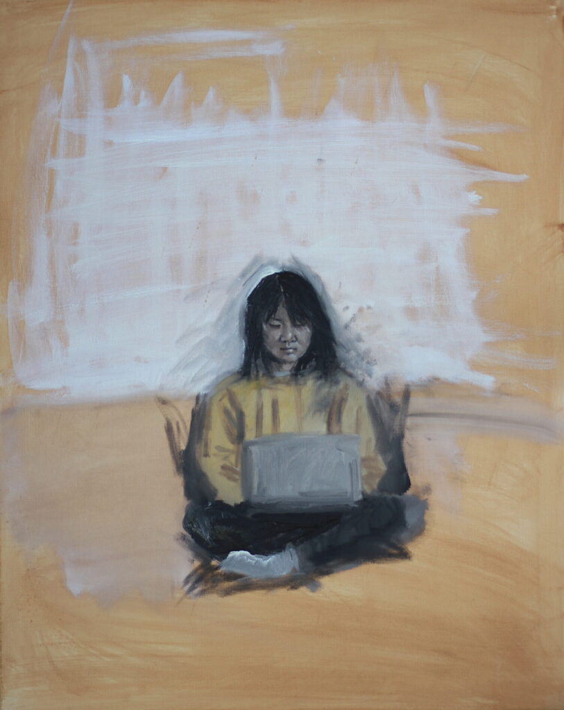A portrait oil on canvas painting, 75cm tall by 60cm wide, Eden working has a peach coloured background, with the upper half painted white in quick vertical and horizontal strokes that roughly blend, and do not reach to the edges. The lower half of the canvas is washed with grey over the peach, blending out from around the subject who is seated here. She is a Vietnamese Australian woman, in her twenties, with straight black hair falling past her shoulders, and an eyebrow-length fringe that reaches down across her left eye. She sits cross-legged, facing us but eyes downcast to the laptop that rests open on the black trousers of her lap. One foot, wearing a white sock, pokes out to the left of the frame, and she wears a yellow jumper, loosely outlined. Her face is carefully detailed, with white highlights amongst the black lines which comprise her features; her eyebrows peeking out from under her fringe, her smooth upper eyelids, her mouth closed, with full lips. Her skin has been rendered in tones of warm-grey and white. Her cross-legged form finishes about an eighth of the way up the frame, as if she is sitting, or perhaps floating, amongst the ethereal, pale turmeric background, with slight shadows beneath her foot and legs.